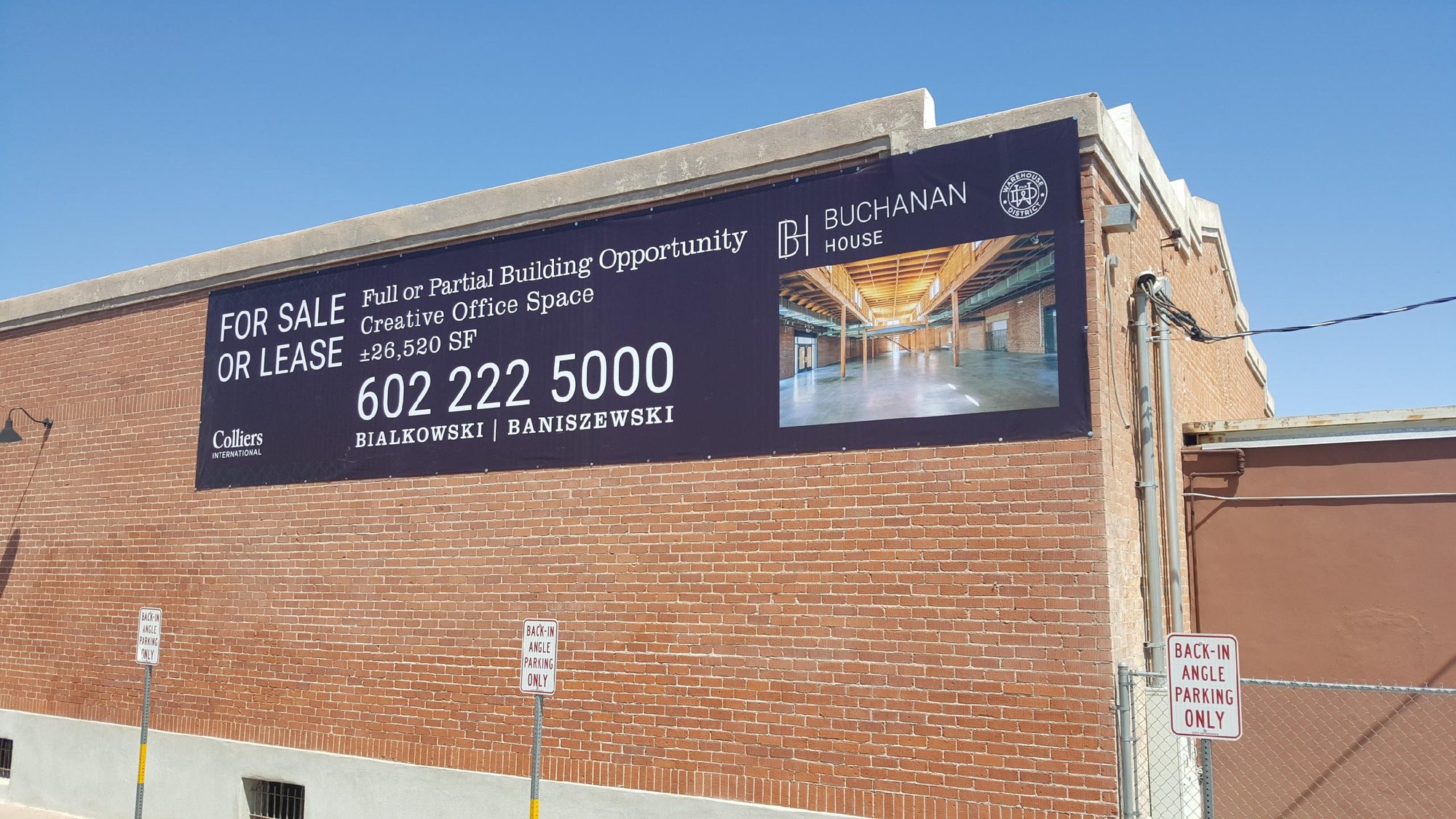 Building banner on the brick facade of Buchanan House in the Warehouse District